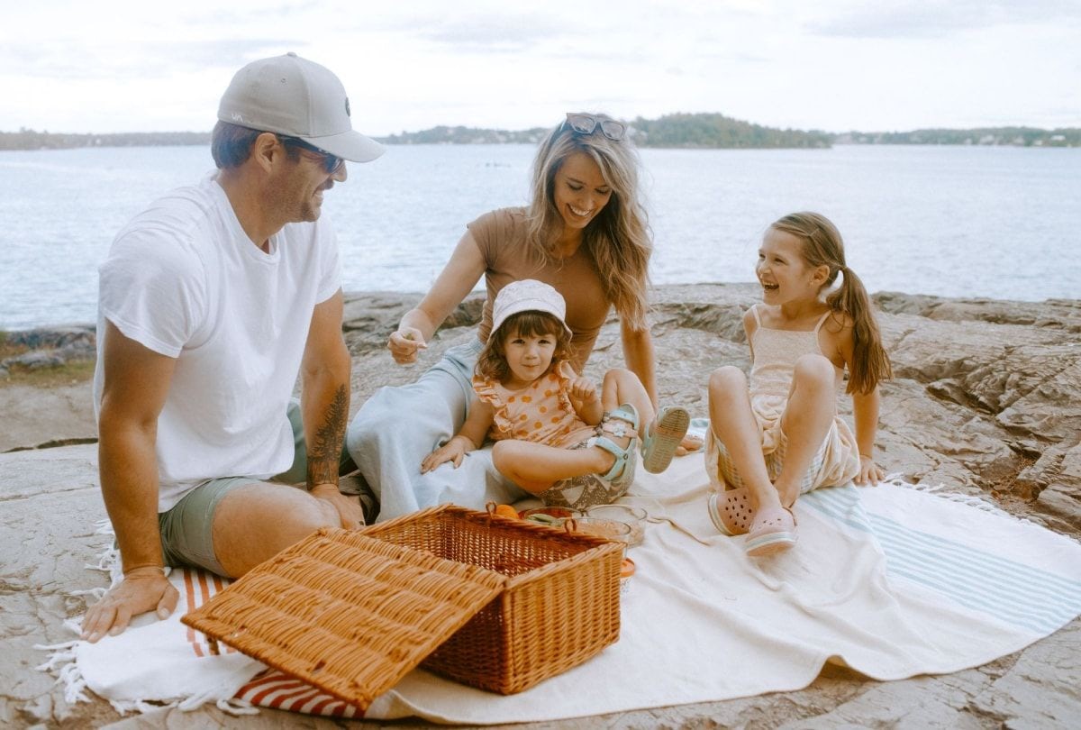 Photo of young family having a picnic at Ramsey Lake in Sudbury, Ontario