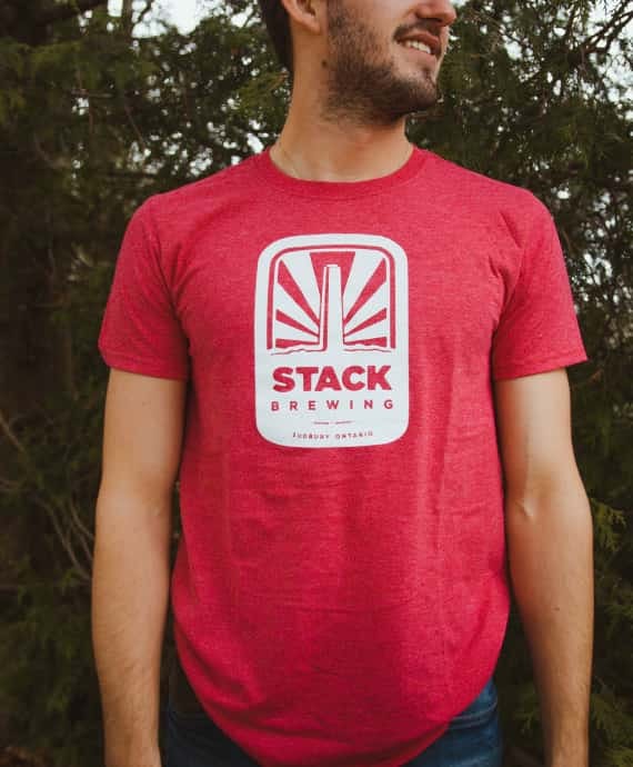 Man wearing red Stack Brewing t-shirt with branded logo on front