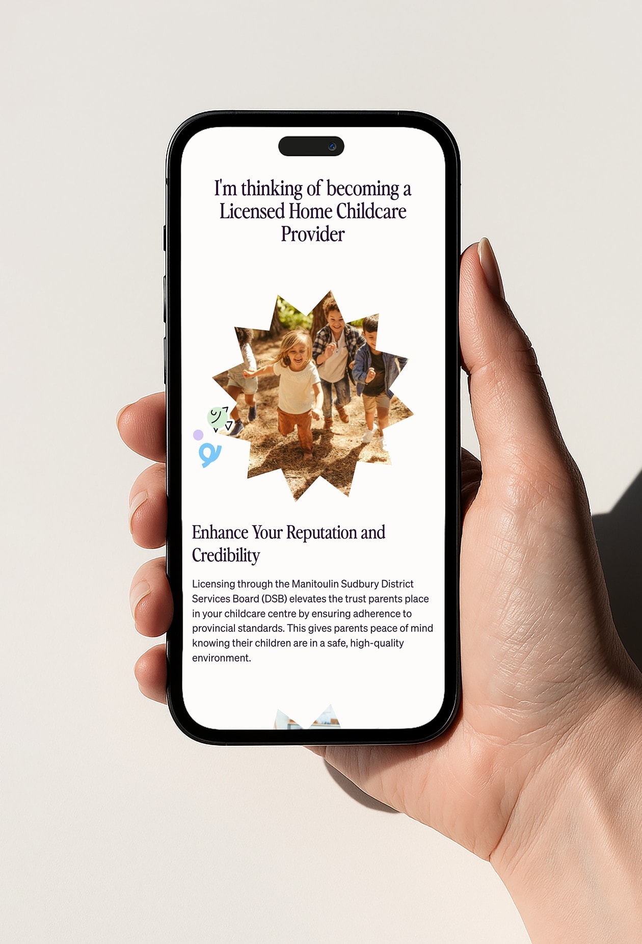 Person holding mobile phone with Playful Work website on it