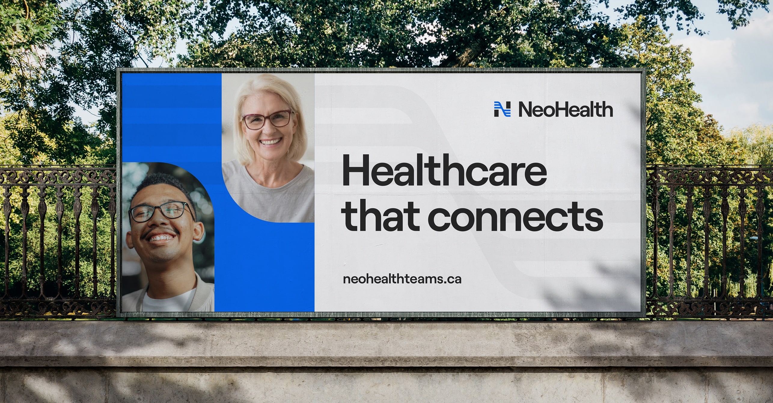 NeoHealth branded billboard, showing smiling portraits of a woman and a man. Headline reads, "Healthcare that connects".