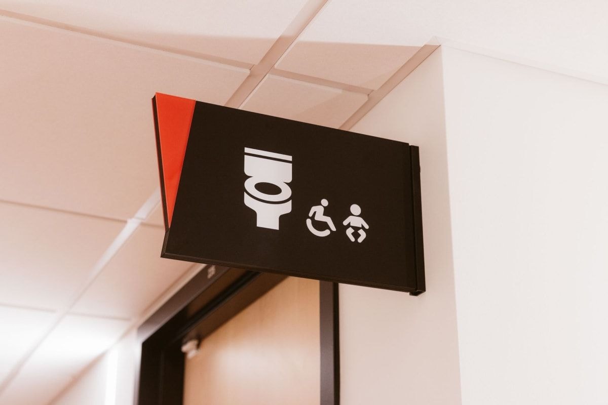 Flag mounted washroom sign at the Place des Arts