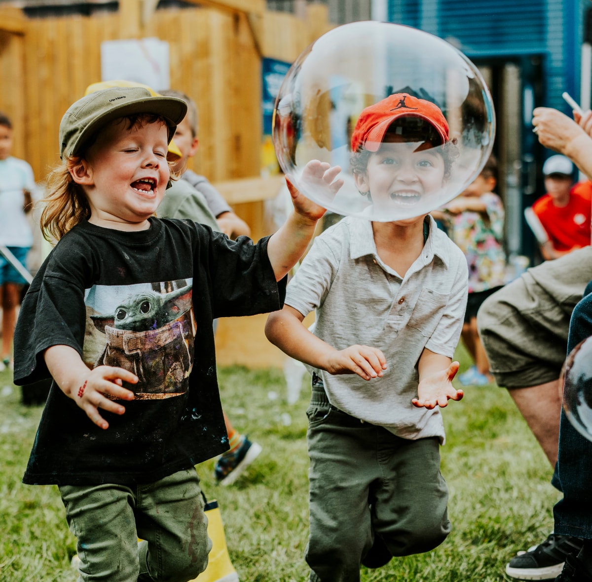 Two children playing with bubbles at Up Here 10 Family Day.